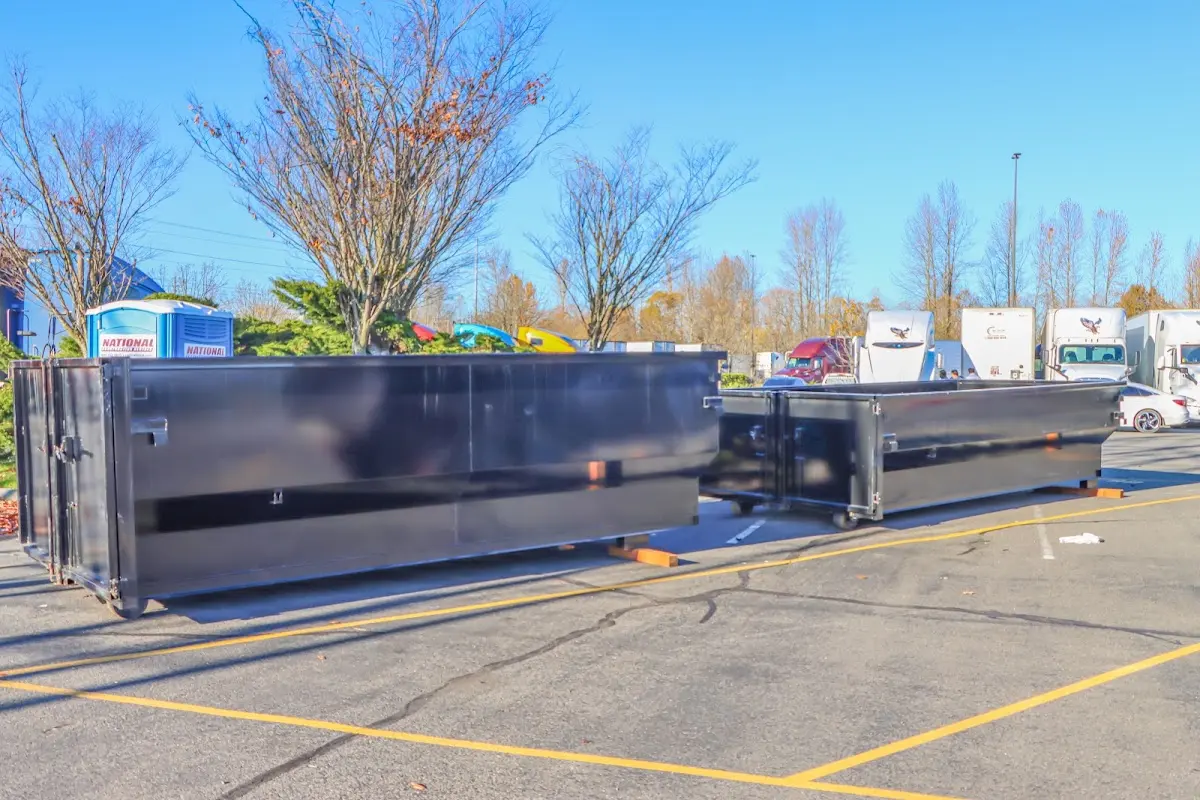 Professional dumpster rental service with roll-off container on residential driveway in Nassau Bay